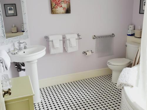 a white bathroom with a sink and a toilet at Adair Country Inn & Restaurant in Bethlehem