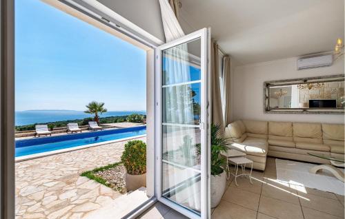 a living room with a view of a pool at Villa Toma in Škunca