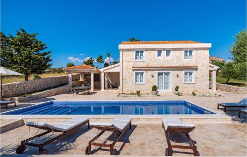 a villa with a swimming pool in front of a house at Villa Toma in Škunca