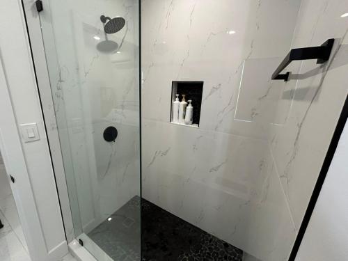 a bathroom with a shower with a glass door at Cute Private Room - Close to airport & Free parking 01 in Miami