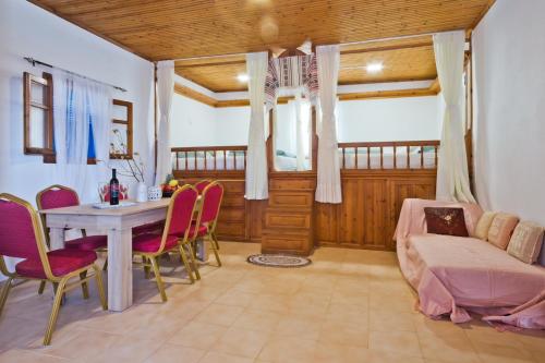 a living room with a table and chairs and a couch at Kouri Traditional House in Karpathos Town