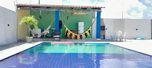 a swimming pool with a slide and a playground at FLAT BRISA do MAR in Pitimbu