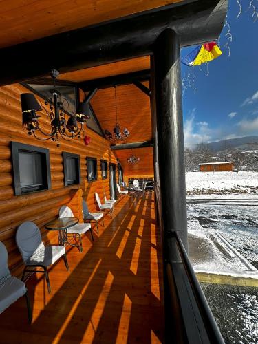 a room with chairs and tables on a building at Domi Chalet in Şişeşti
