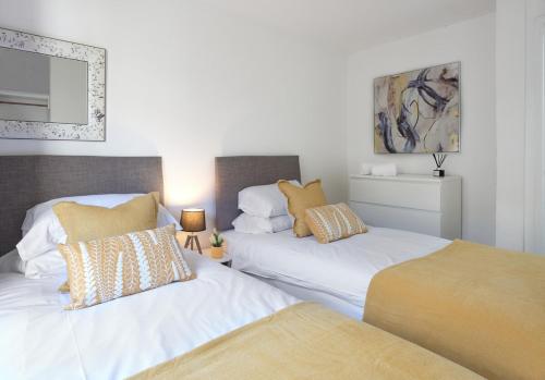 two beds sitting next to each other in a room at The Lush Apartment Cardiff Central 2 Bedrooms in Cardiff