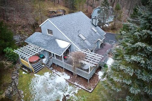 an aerial view of a house with a deck at Designer Chalet with Hot Tub and Fire Pit in Margaretville
