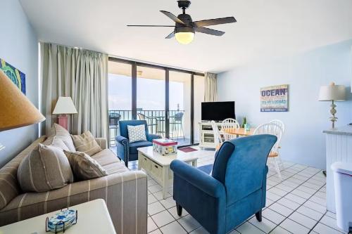 a living room with a couch and chairs at Octopus Garden 1BR, King Bed, Indoor & Outdoor Pool in Carolina Beach