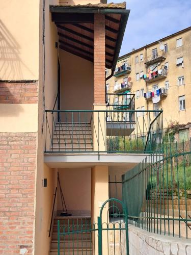 an apartment building with a balcony and a building at 8380 La Cantina di Piero&Netta in Montemerano