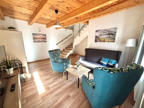 a living room with blue chairs and a couch at Apartmány Rosenberg in Rožmberk nad Vltavou