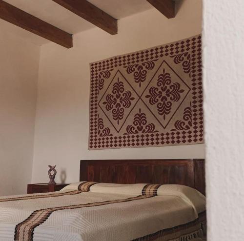 a bedroom with a bed with a brown wall at Nuragic Temple in Esterzili