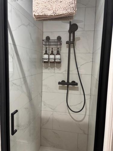 a shower with a shower head in a bathroom at Brand New city Centre Flat, WiFi, Free Private off-site parking in Nottingham