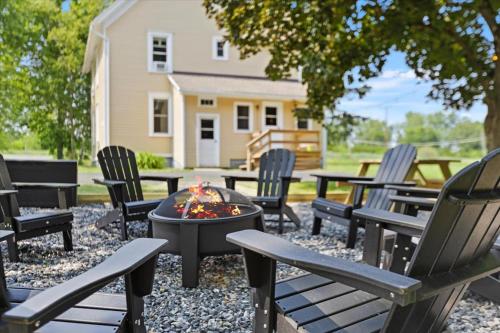a group of chairs sitting around a fire pit at Hudson Restored Farmhouse with Fire Pit in Hudson