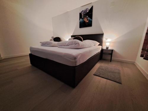 a bedroom with a bed with two people laying on it at Apartments Orlić - Self check-in with code, WI-FI, Netflix, smart TV, garden in Zagreb