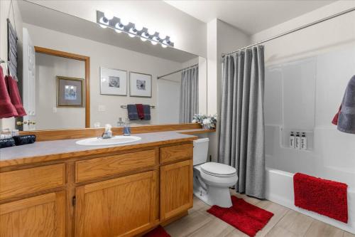 a bathroom with a sink and a toilet and a shower at Blue Grass Bungalow in Coeur d'Alene