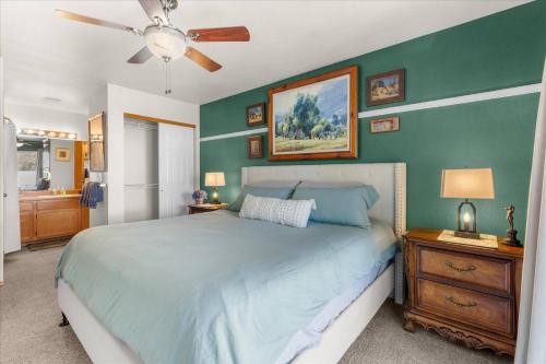 a bedroom with a bed and a ceiling fan at Blue Grass Bungalow in Coeur d'Alene
