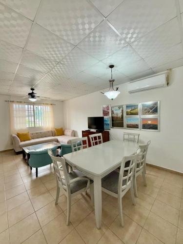 a living room with a table and chairs and a couch at La Placita - Apartamentos in Las Tablas