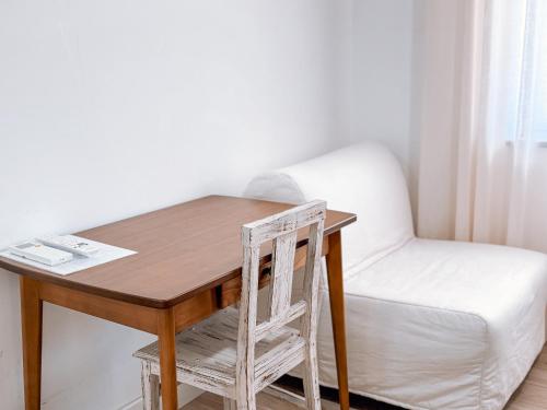 a wooden table with a chair next to a desk at Ninho D'Arara in Tondela