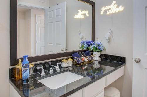 a bathroom with a sink and a large mirror at A Taste of Greece -1BR - NRG - MD Anderson - Galleria in Houston
