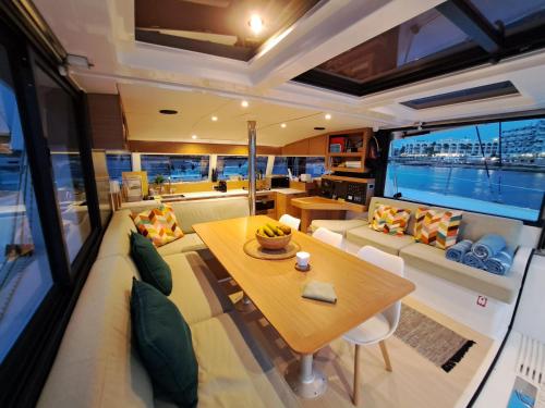 a living room and dining room on a yacht at Dortoka Catamarán in Sitges