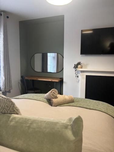 a bedroom with a bed with a tv on the wall at Brand New City Centre Apartment - Free offsite Parking Available in Nottingham