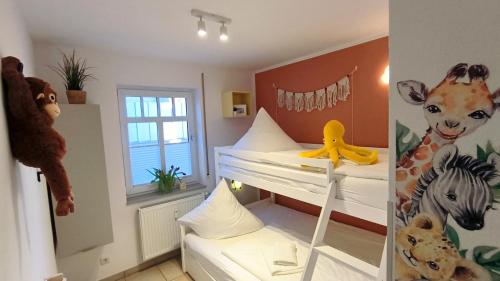 a bedroom with two bunk beds with stuffed animals at Ferienwohnung OstseeBlick Rerik in Rerik