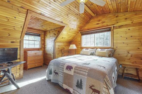 a bedroom with a bed in a log cabin at Bear’s Den in Sautee Nacoochee