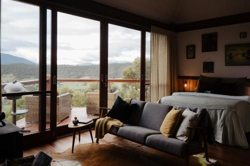 a bedroom with a bed and a large window at Kangaroo Ridge Retreat in Healesville
