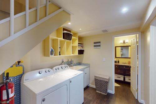 a laundry room with a white washer and dryer at Whistle Stop Cabin in Lake Arrowhead