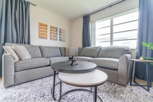a living room with a couch and a table at Modern Chic Getaway - Sleeps 11 - Palmwavestays in Coconut Creek