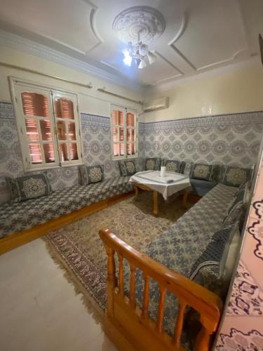 a living room with a couch and a table at Sunny City Villa with a Garden in Erfoud