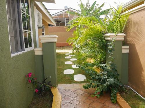 a garden with plants on the side of a house at 2 BDR House near Martha Brae River rafting in Falmouth