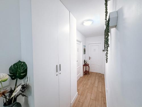 a hallway with white walls and a wooden floor at Ninho D'Arara in Tondela