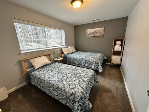 a bedroom with two beds and a window at Iron Hill in Lake Harmony
