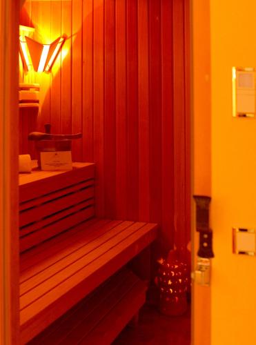 a wooden bench in a room with a light at Hotel BEI SCHUMANN in Kirschau