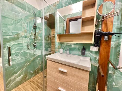 a bathroom with a sink and a shower at CANTU' SUITE in Catania