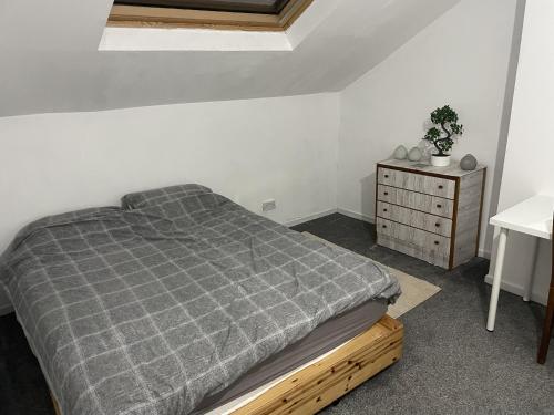 a bedroom with a bed and a dresser at 123a Antrim Rd in Belfast