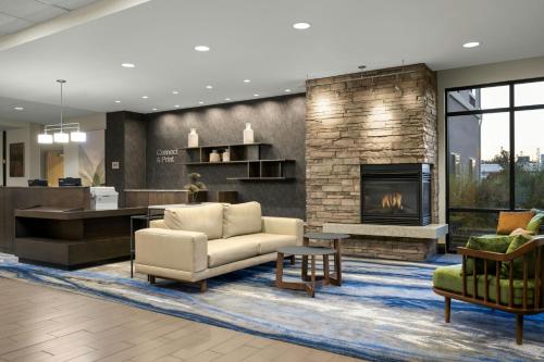 a living room with a couch and a fireplace at Fairfield Inn & Suites by Marriott Moscow in Moscow