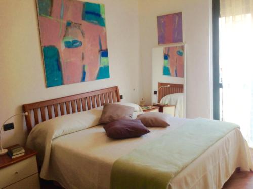 a bedroom with a bed with two pillows on it at Camere Delle Rose in Milan