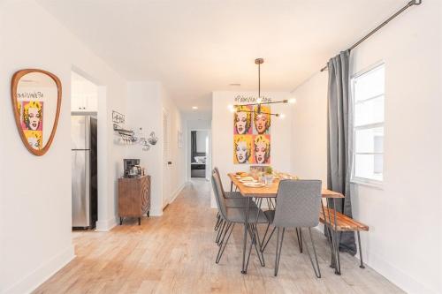 a dining room with a table and chairs at Ocean Whisper - Sleeps 11 - Palm Wave Stays in Coconut Creek