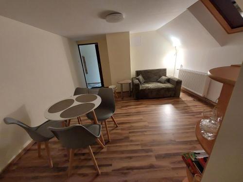 a living room with a table and chairs and a couch at Tygiel Krzywa, Beskid Niski in Krzywa