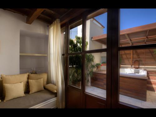 a living room with a window and a couch at Palazzo Duca in Chania Town