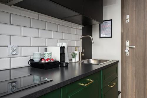 a kitchen with a sink and a counter top at Kairos Apartments - Royal Premium - parking podziemnym gratis, ścisłe centrum in Gliwice