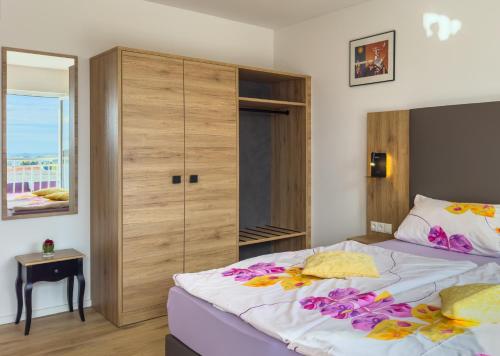 a bedroom with a large bed with flowers on it at Hotel Restaurant Traube Kallstadt in Kallstadt