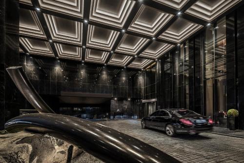 a car parked in front of a building at Four Seasons Hotel Seoul in Seoul