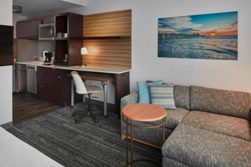 a living room with a couch and a table at TownePlace Suites by Marriott Fort Myers Estero in Estero