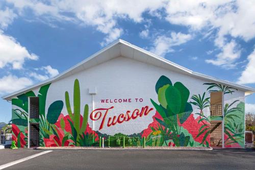 a building with a mural on the side of it at The Kennedy Tucson, SureStay Collection by Best Western in Tucson