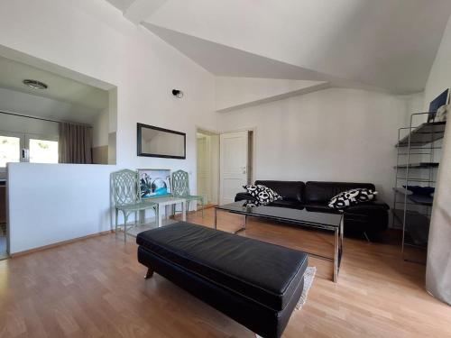 a living room with a couch and a table at Old Vineyard Estate in Buna