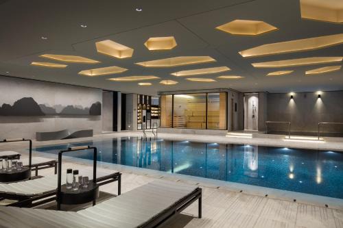 a pool in a hotel with a swimming pool at Four Seasons Hotel Seoul in Seoul