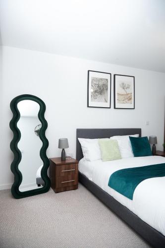 a bedroom with a bed and a large mirror at Luxury 2 Bedroom and bathroom in Central Manchester With Balcony in Manchester