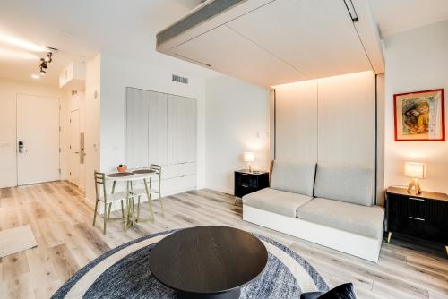 a living room with a couch and a table at View of Hollywood Sign Studio, Free Parking in Los Angeles