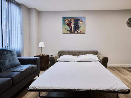a living room with a bed and a couch at Birmingham Gem 2-Bed with Netflix, Fun & Parking in Birmingham